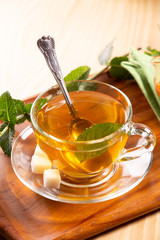 Fresh hot tea and mint on a tray