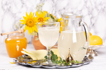 Refreshing drink with lemon and honey on a tray
