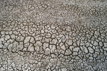 Dry lake bed with natural texture of cracked clay in perspective floor