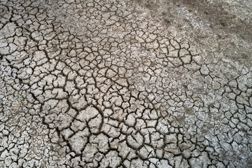 Dry lake bed with natural texture of cracked clay in perspective floor