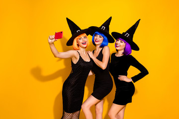 Live broadcasting from theme party. Photo of three friendly charming magic fantasy fairy mysterious cool in caps ladies making selfie isolated vivid color background