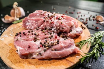 Raw beef steak on a dark wooden table