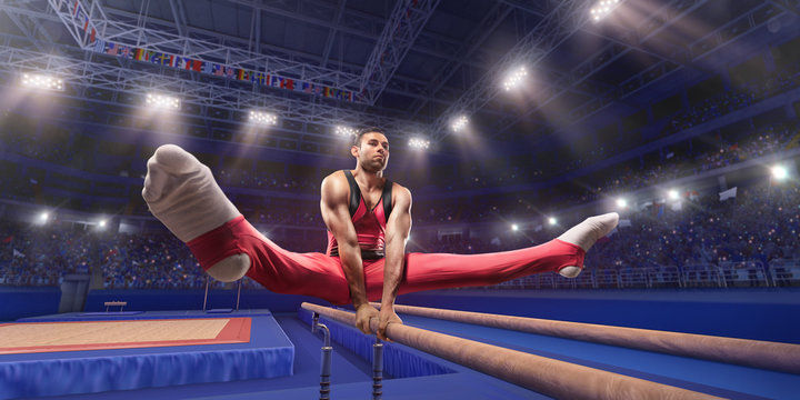Male athlete doing a complicated exciting trick on parallel bars in a professional gym. Man perform stunt in bright sports clothes