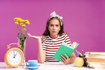 Attractive young girl sitting at the desk