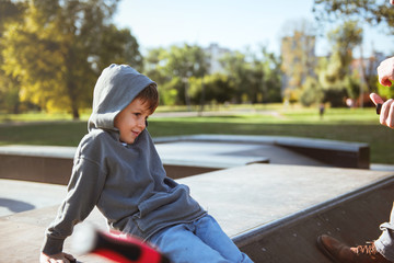 Little boy spending the day with his father in Skate park