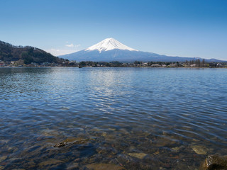 Natural landscape view of the Kawaguchi Lake with mount Fuji-the most beautiful vocano in Japan and rock under water in  foreground