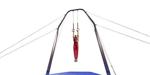 Male athlete doing a complicated exciting trick on gymnastics rings on white background. Isolated...