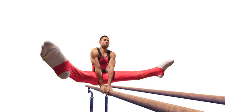 Male athlete doing a complicated exciting trick on parallel bars on white background. Isolated Man perform stunt in bright sports clothes