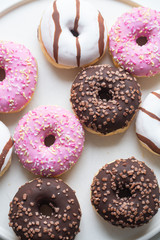 Colorful donuts on marble background with copy space