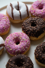 Colorful donuts on marble background with copy space