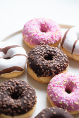 Colorful donuts on marble background with copy space