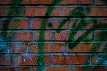 Texture of an old paint covered brick wall. Background image of an abandoned brick wall with painted over paint