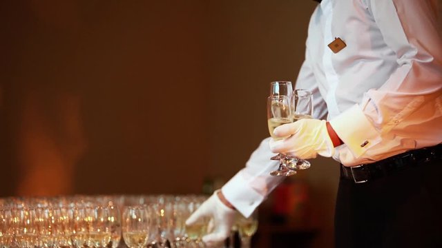 Elegant champagne glasses standing in a row and red roses petals. Wedding anniversary 