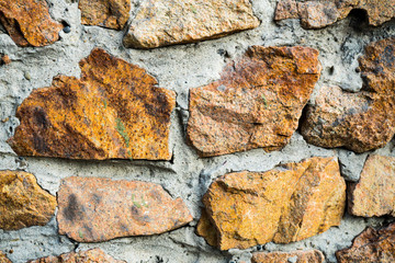 The texture of the old masonry. Background image of a stone-lined wall