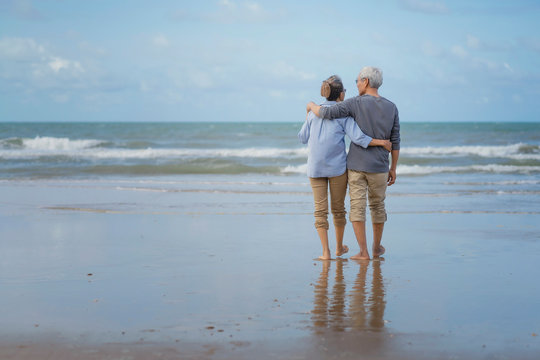 Asian couple senior elder retire resting relax walking running at the beach.Honeymoon family together happiness people lifestyle.Mature couples relax at the seaside on holiday.