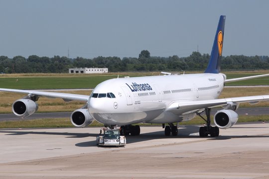 DUSSELDORF, GERMANY - JULY 8: Lufthansa Airbus A340 is pushed back on July 8, 2013 in Dusseldorf Airport, Germany. Lufthansa Group carried over 103 million passengers in 2012.