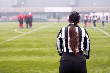 rear view of female american football referee
