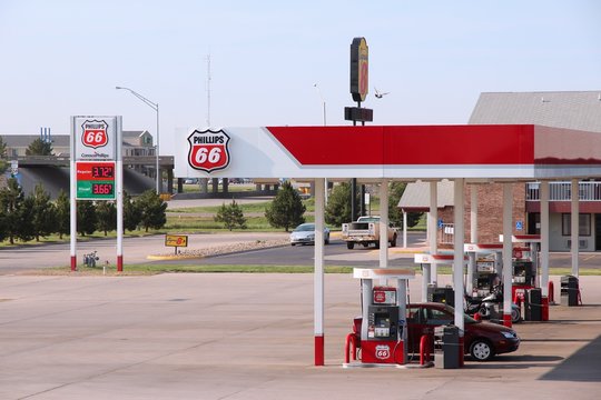 GOODLAND, KANSAS - JUNE 25: People fill their tanks at Phillips 66 gas station on June 25, 2013 in Goodland, Kansas. Phillips 66 had revenue of US$ 166 billion in 2012. It employs 13,500 people.