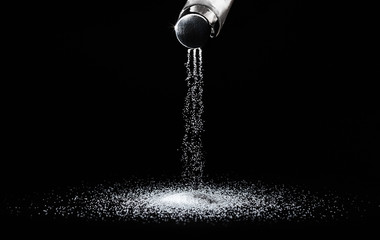 Obraz na płótnie Canvas Salt shaker on a dark background