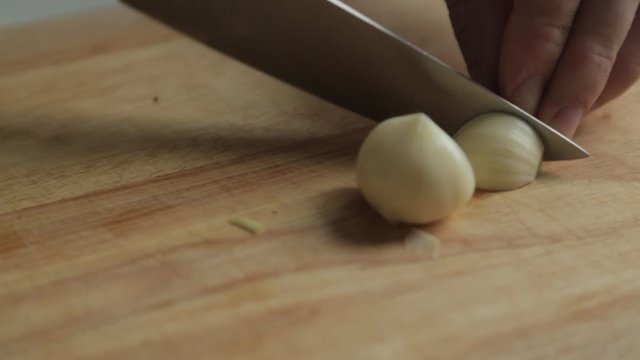  Cooking and slicing garlic. Content and macro photography for food blog.