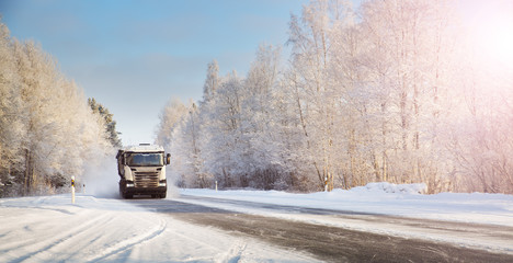 truck on winter road covered with snow