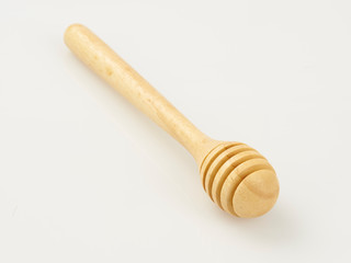 wooden honey dipper on white background