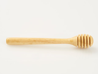 wooden honey dipper on white background