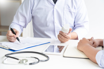 Fototapeta premium Doctor explaining and giving a consultation to a patient medical informations and diagnosis about the treatment for condition in hospital, medical ethics concept