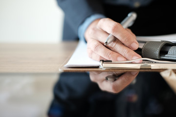 Fototapeta premium businessman working organizing plan with notebook at workplace