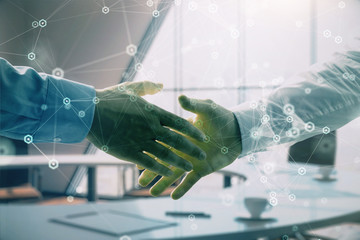 Multi exposure of tech theme hologram on office background with two men handshake. Concept of...