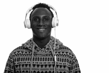 Young happy black African man smiling and listening to music