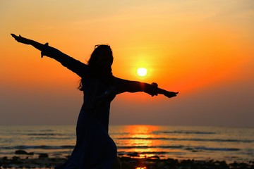 silhouette of young woman on sunset