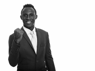 Young happy black African businessman looking motivated