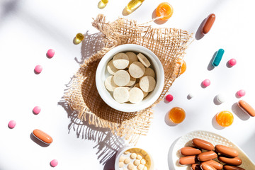 Nutritional supplements and vitamins on white background. Medicines for health support. Pills and supplements for people health.