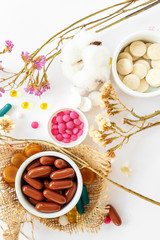 Nutritional supplements and vitamins on white background. Medicines for health support. Pills and supplements for people health.