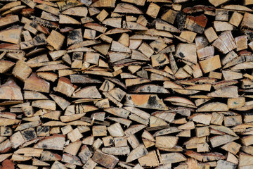 The texture of stacked wood. Firewood stacked in a woodpile. Close up