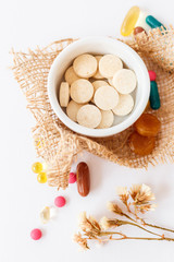 Nutritional supplements and vitamins on white background. Medicines for health support. Pills and supplements for people health.