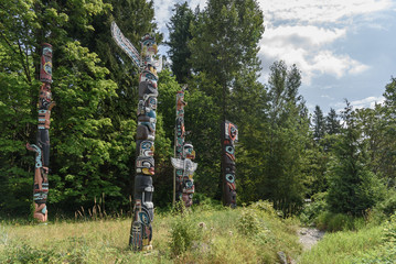 Totem poles located in a clearing of a forest