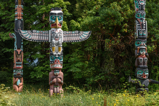 Totem poles located in a clearing of a forest