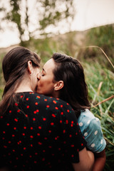 Fototapeta premium Two young women embraced on the field