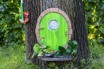 small fabulous wooden house with a door attached to a tree in the Dnieper city park