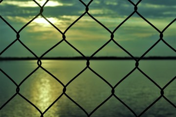  the evening sky through the bars