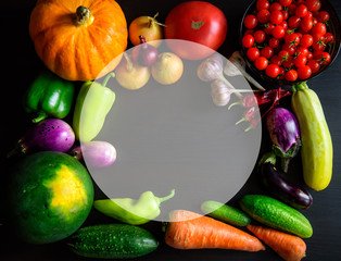 Autumnal assorted fresh vegetables on black wooden table. Organic food. Thanksgiving day concept. Top view frame with autumn harvest and copy-space. Layout with free text space.