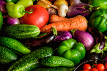 A pile of various vegetables on the table, water drops on fresh vegetables. Harvest from the garden. Vitamins, longevity foods, organic meal.