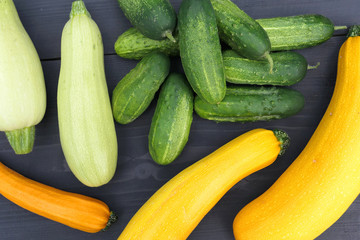 Fresh harvested home grown yellow zucchini squash and green cucumbers