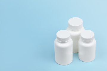 Blank medical white plastic vitamin bottles background