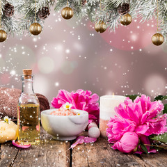 Christmas Spa concept. Gift. Massage, towel and other thing. Holiday blur background and balls. 