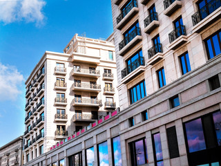 Residential multi-storey building with balconies and a shop on the ground floor 