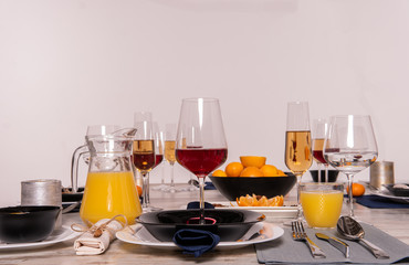 Rustic table setting with pink flowers and candle on light wooden table. Holidays decoration on Provence style. Romantic dinner. Overhead