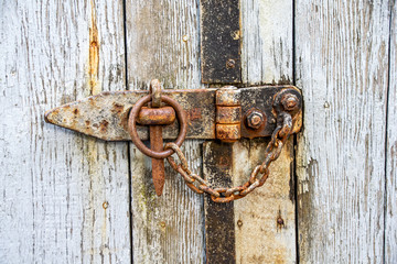 Rusty chain and lock on a wooden door